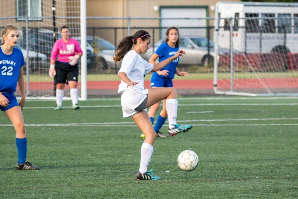 Junior Cora Rainwater takes control of the ball in a junior varsity girls soccer match against McNary