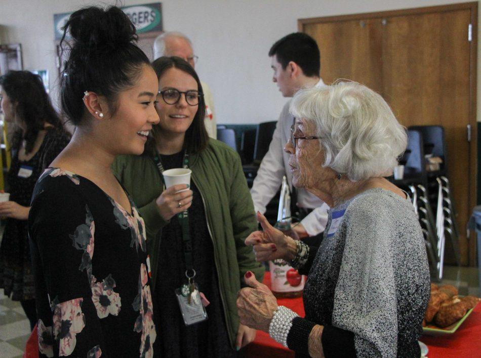 Senior Brittney Eng chats with one of the senior citizens during the senior citizen prom.