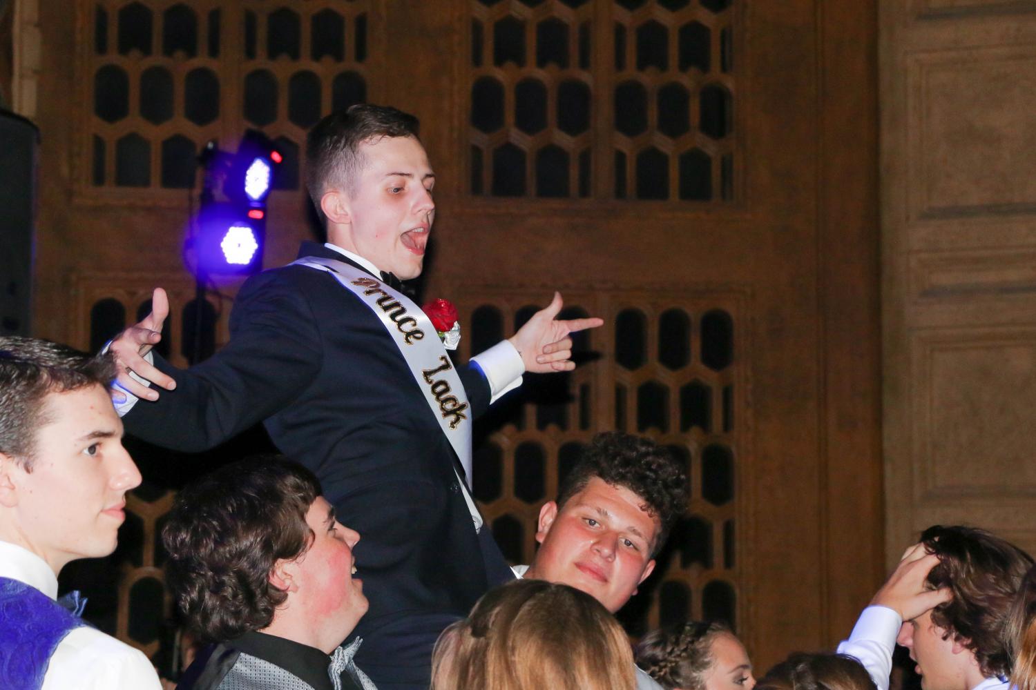 Last years prom king, Zack Dean, being lifted by the crowd at prom.