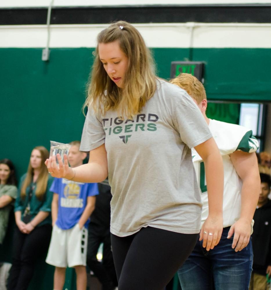 Annie Nihill competes in the cup of water walk for her senior team at the back-to-school assembly.