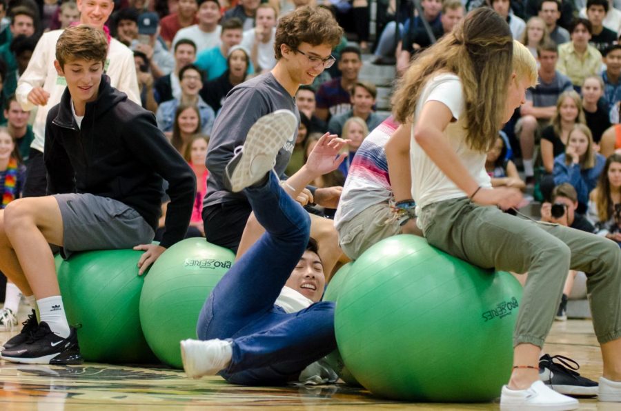 Students fight for the last seat in a musical chairs-style game with exercise balls.