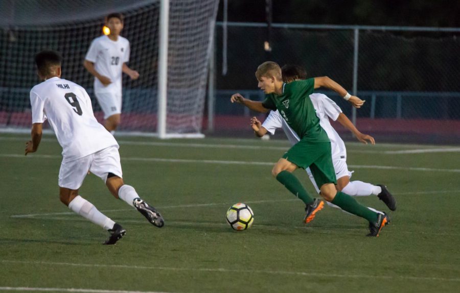 Junior Midfielder Trevor Smith (3) creates an attack play against two defenders from Hillsboro High School. Tigard won 1-0. 
