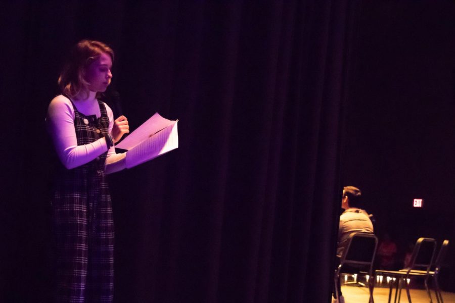 Chloe Skinner reads her story at HR Assembly on March 14. Skinner and a  specially selected group of students read stories about their struggles from behind the theater curtain. Afterwards, they all elected to go out on stage and reveal themselves to their peers.