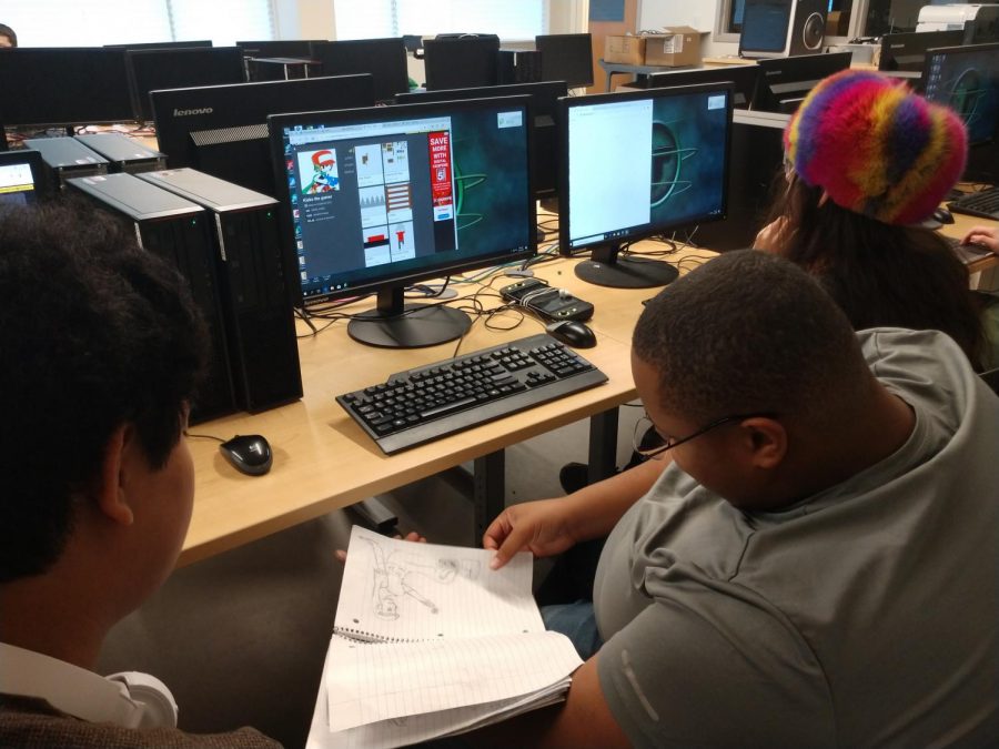 From left to right: Khanh Nguyen (10), Xavier Walker (12) and Jimmy Nguyen (12) look through a sketchbook to compile ideas for their game. Studio Gemini is recruiting members to compete in this years OGPC.