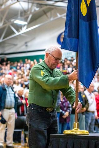 Mark Lueck helps Head Custodian Gus Jaramillo with the presentation of the colors and placing the Oregon state flag.
