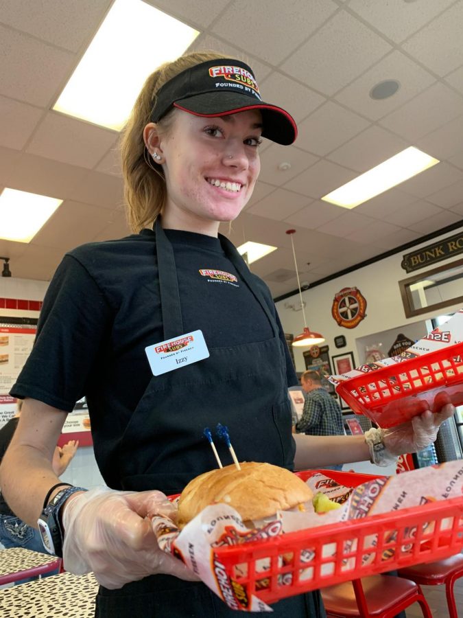Junior Isabelle Ford is pictured working at her job, Firehouse Subs. She says finding time for homework, combined with a job, is tricky.