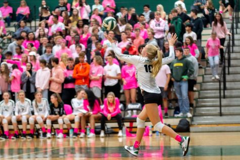 Sophomore volleyball player Kaitlynn Peterson serves the ball during the Dig Pink game against Lakeridge. The team only won one set, but they raised $859 for breast cancer.