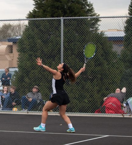 Tigard alumna Nicole Mazzeo plays at the schools old tennis court. This year, the girls tennis team faces freezing weather as the season begins.