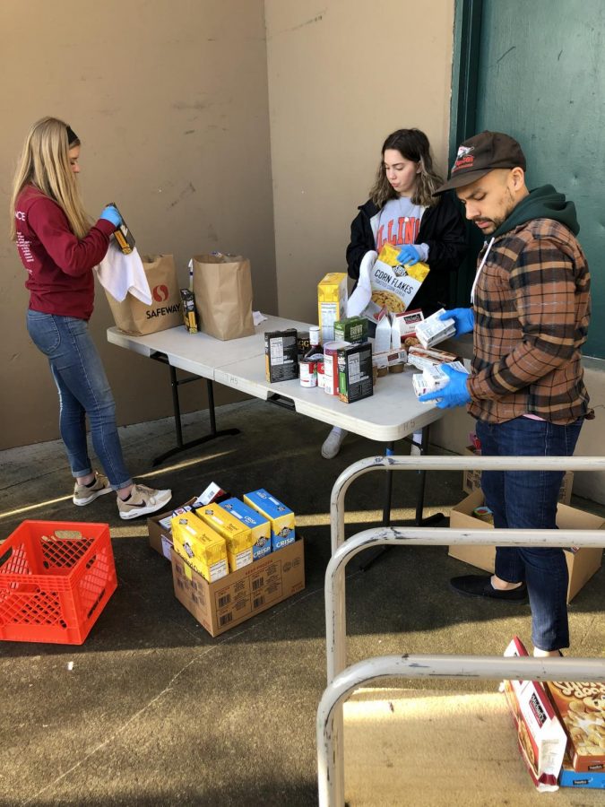 Student and community volunteers work to sanitize food before sorting it. So far, Packed with Pride has collected commitments from over 500 volunteers. 