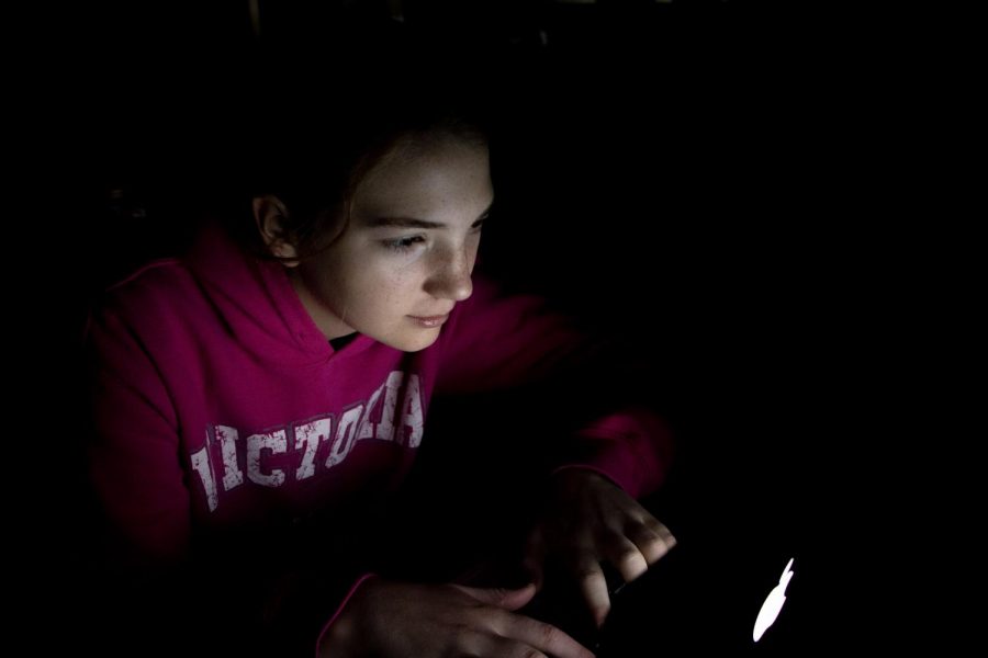 Without a typical school year schedule, teens do work into the wee hours of the morning. Hannah Currier worked on a slam poem for her language arts class, the room illuminated by the light of the computer screen.