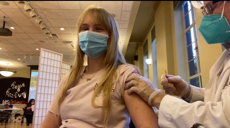 Senior Rietta Thomson gets her COVID vaccine. She was able to get her vaccine before it became available for everyone 16 years and older. I got the vaccine because I work at a retirement home, Thomson said.  I feel it is my responsibility to protect the elderly I work for.
