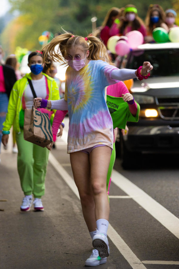 Junior Alyssa Thoren dances her way down Durham Road. On Oct. 8 some homecoming events continued as usual like the parade and football game. Powderpuff and the dance were postponed.