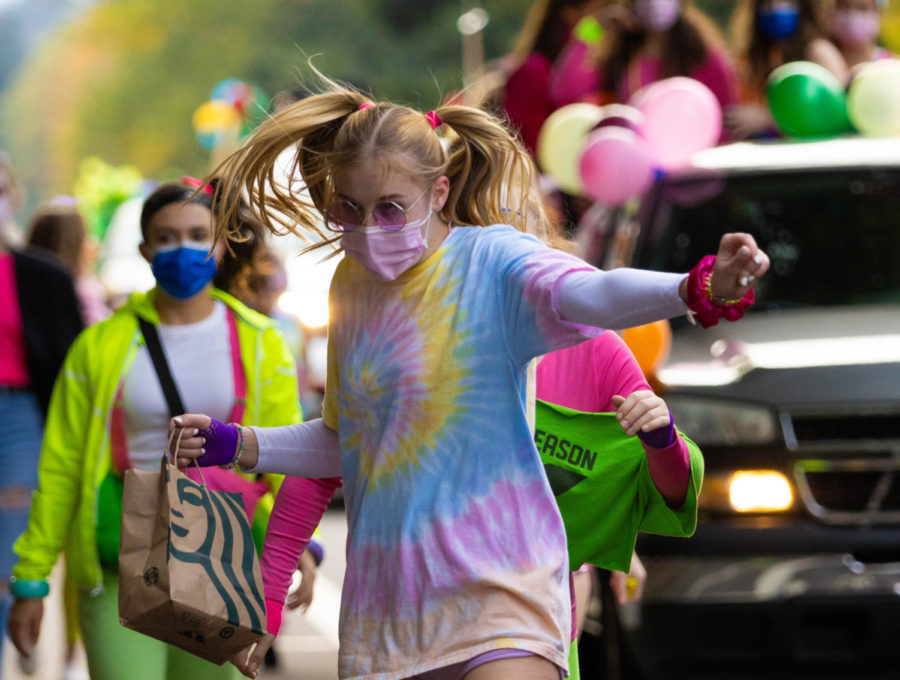 Junior Alyssa Thoren dances her way down Durham Road. On Oct. 8 some homecoming events continued as usual like the parade and football game. Powderpuff and the dance were postponed.
