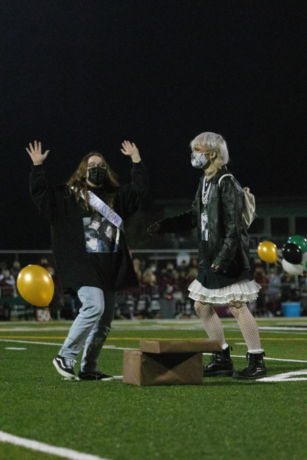 Seniors Charlotte Wendt and Ryan Curry skip towards center field. During halftime at the Oct. 8 football game, homecoming court was announced. Wendt was thrilled when she saw she had received the golden balloon. I was so excited, Wendt said. Ryan and I accidentally shut the box again, so we just started celebrating for everyone else.