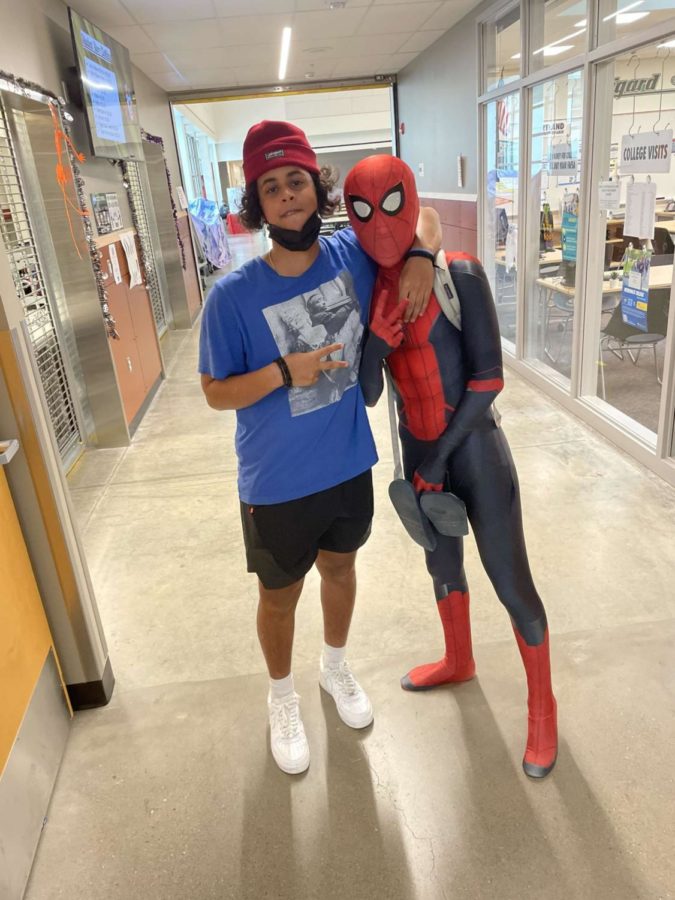 Sophomore Maalik Barkhadle has his picture taken with Spiderman during school on Oct. 27. Some students dressed up for Halloween on the last day of classes before the holiday. Spidermans real identity remained a secret.
