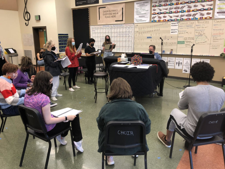 Choir Director Robert Hawthorne leads a practice for the fall musical All Together Now! The show will be performed by 2,500 theater groups across the country from Nov. 12-15.