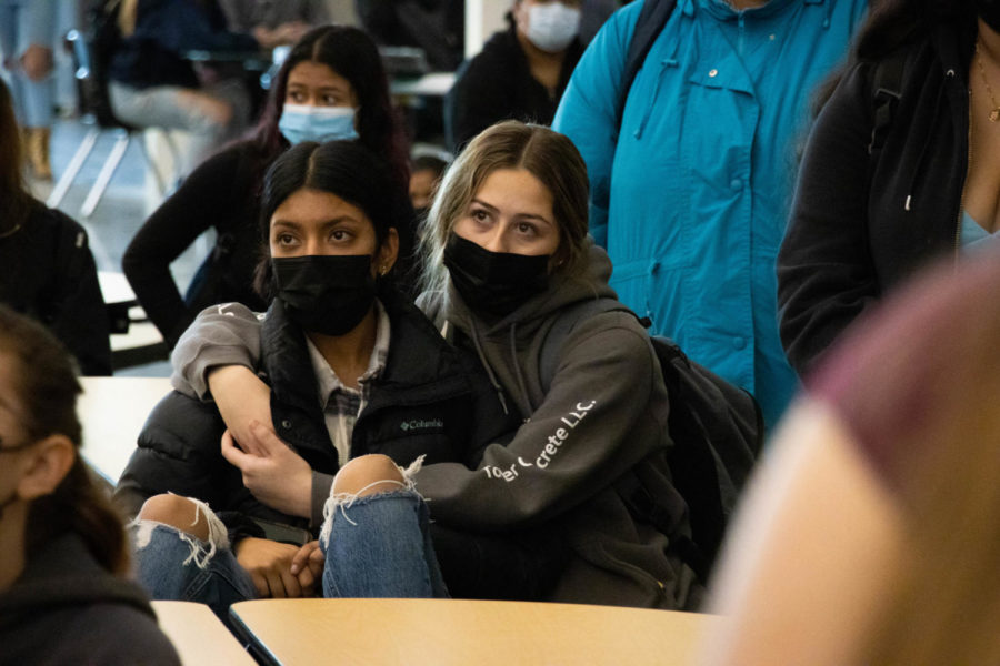 Seniors April Avila Jacome and Elliana Davila sit in an embrace listening to the experiences shared by peers at the Dec. 1 walkout. During the protest students took the microphone and shared personal experiences with racism.