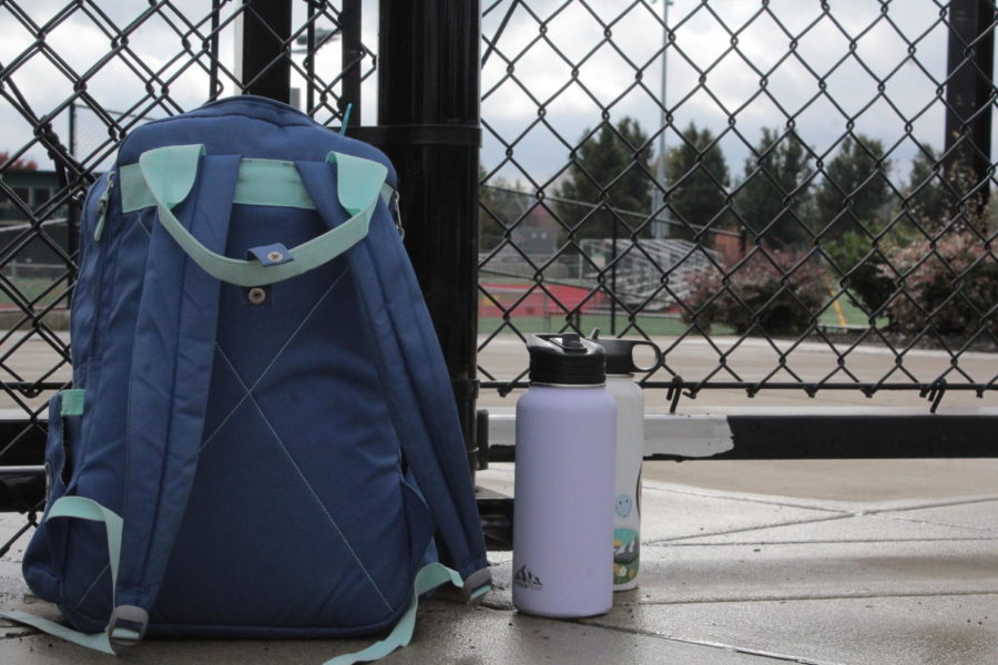 A+backpack+and+water+bottles+sit+outside+the+fences+surrounding+the+football+field.+