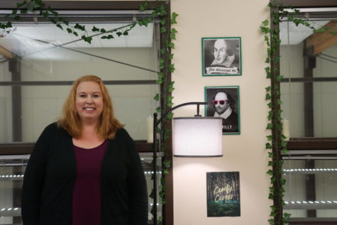 Carrie Stock smiles in her new classroom which overlooks the library. 